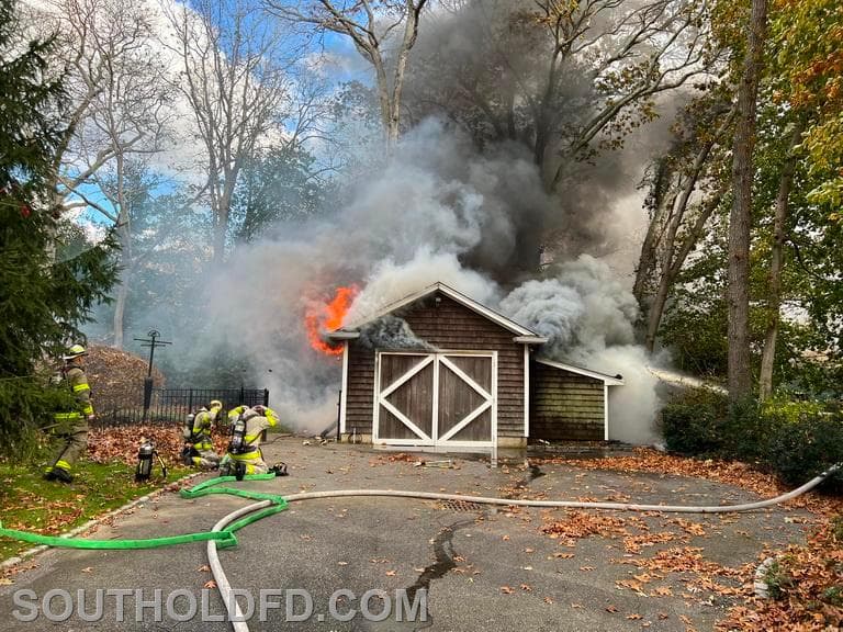 Garage and surrounding brush fire near Indian Neck Lane